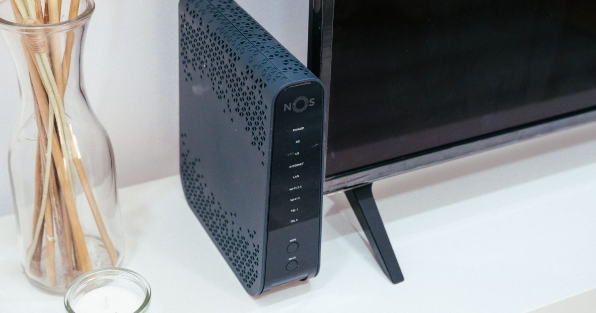 A sleek home technology setup featuring a router, glass decoration, and television.
