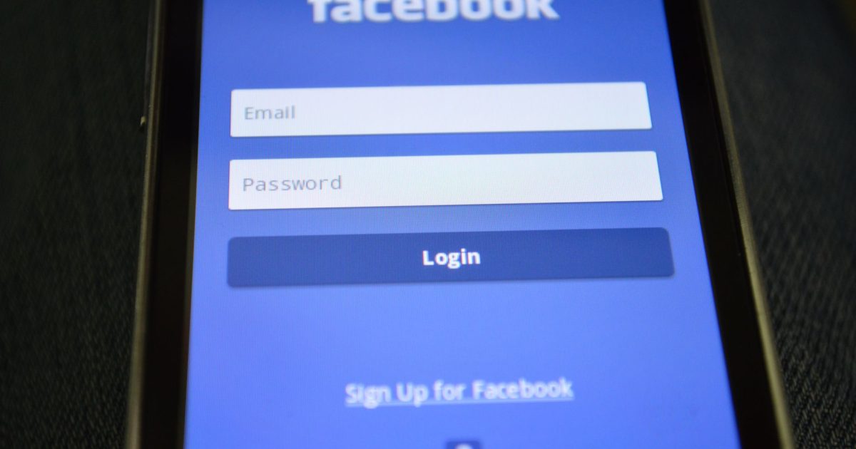 Close-up of a smartphone screen showing the Facebook login interface.