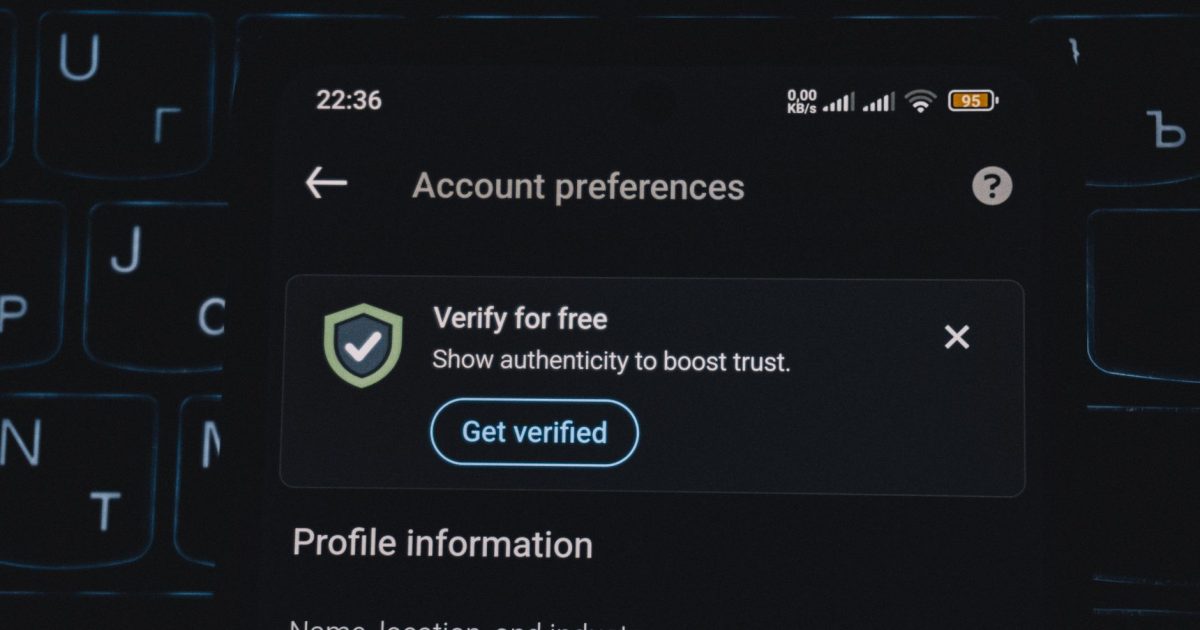 Close-up of a smartphone screen displaying account verification alert. Ideal for security and authenticity themes.